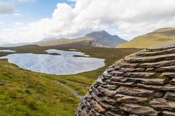 Lochan an Ais and Cul Beag  as seen from „The Globe“  by Joe Smith close to hiking trail at Knockan Crag in North West Highlands Geopark, Scotland