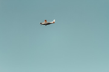 Small airplane flying against blue sky