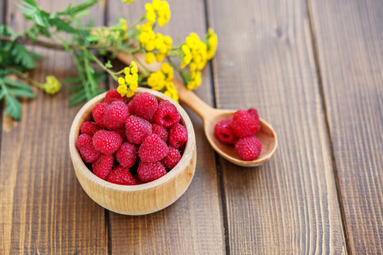 Tasty raspberry. Juicy berry. Summer. Top view. The concept is healthy food, diet, vegetarianism, vitamins.