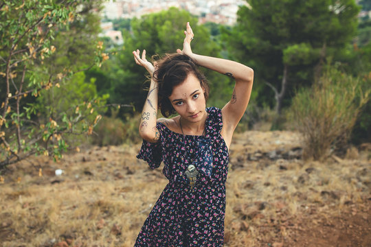 Young woman with tattoos in nature