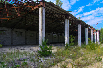 An old abandoned garage for repairing vehicles in the zone. Dead military unit. Consequences of the Chernobyl nuclear disaster, August 2017.
