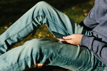 Teenage boy using a telephone with broken screen