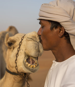 A Man and his Camel Share an Intimate Moment