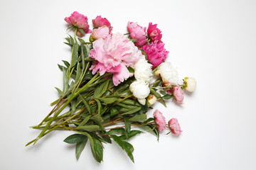 Obraz na płótnie Canvas A bouquet of pink peonies lies on a white background.