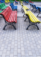 Fototapeta na wymiar Multicolored benches in park