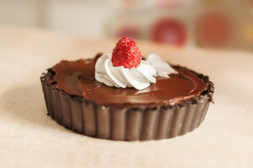 Chocolate cake with whipped cream and raspberry
