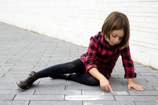 Young curious??_girl reclined on ground.
