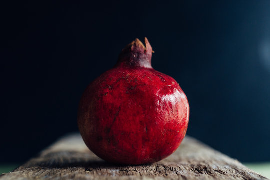 Pomegranate on a piece of wood