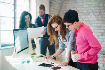 Group of young architects using digital tablet