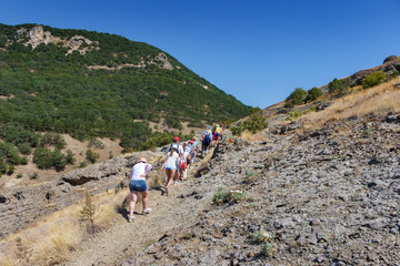 Fototapeta premium A group of people traveling through the mountains in the Crimea