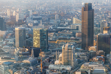a view of city of London during sunset with yellowish light