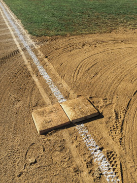 View of first base and painted boundary line on baseball field