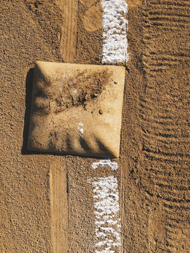 View of first base and painted boundary line on baseball field