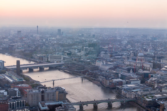 A View Of Thames River And London At Sunset With Red Sky And Air Pollution