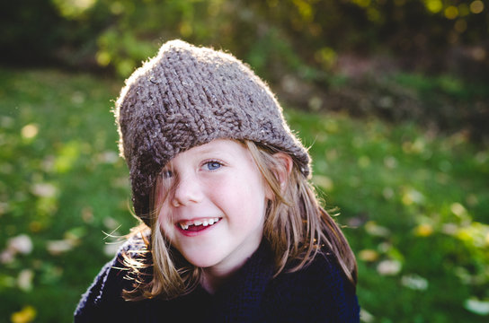Girl wearing hat lopsided and smiling