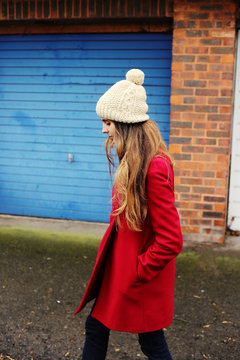 Woman walking the street in a red coat