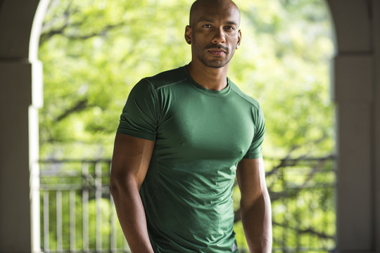 A fit man looking at the camera, straight faced