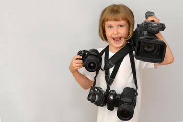 Pretty baby (a little girl) with cameras and a video camera on white background space for lettering.