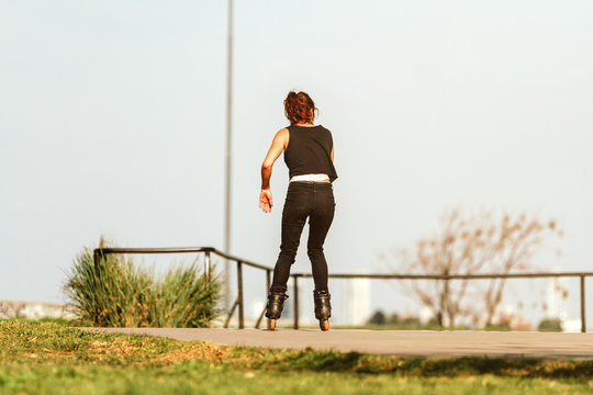 Woman skating on roller skates at a skatepark