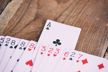 Playing cards on wooden table  