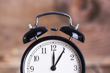 Close up of Alarm clock on wooden background  