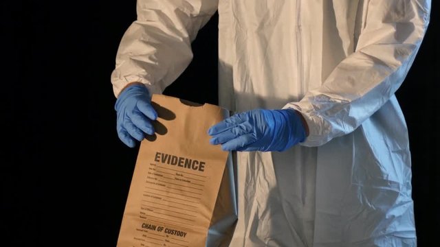 Crime scene forensic detective, weapon placed into evidence