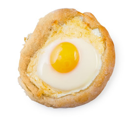 Caucasian delicious Ajarian khachapuri with egg isolated on white background, top view.