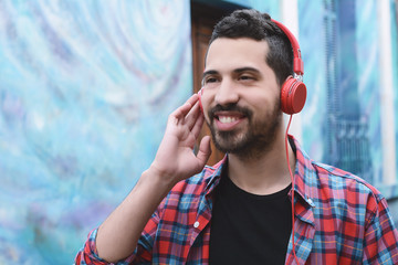 Latin man listening music with headphones.