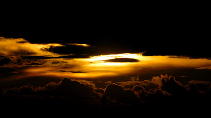 sunset behind dark cloud