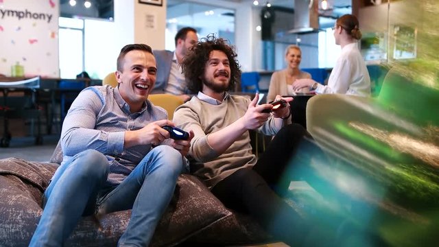 two coworkers playing games in startup office
