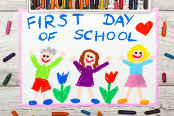 Obraz na płótnie Canvas Photo of colorful drawing: Word FIRST DAY OF SCHOOL and happy children