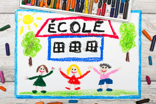 Photo of  colorful drawing: French word SCHOOL, school building and happy children. First day at school.