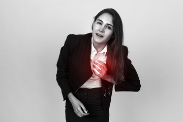 Beautiful young businesswoman with heart attack or broken heart. Black and white with red accent