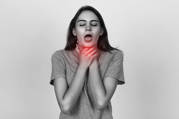 Young woman with sore throat. Black and white with red accent