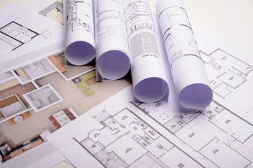 Architect rolls and plans construction project drawing