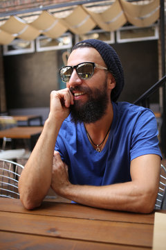 Bearded man with sunglasses looking away