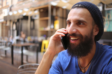 Bearded man talking on phone and smiling