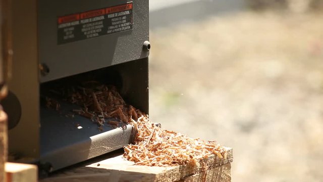 Wooden splinters and particles coming out from a jointer saw contractor operation