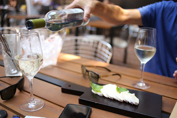 Pouring wine in glass. Close up