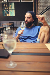 Pensive man holding glass of wine