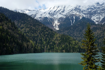 Fototapeta na wymiar Mountain lake and evergreen forest