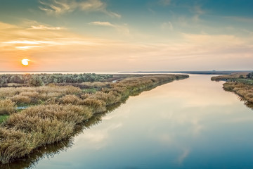 Autumn sunset over the river mouth