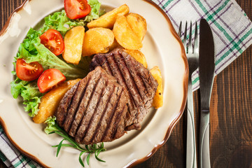 Succulent portions of grilled fillet mignon served with baked po