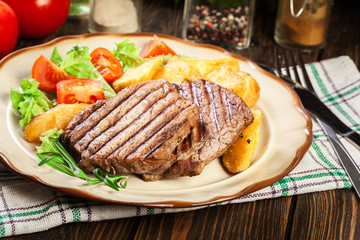 Succulent portions of grilled fillet mignon served with baked potatoes