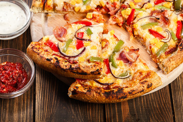 Homemade pizza with bacon, paprika and corn