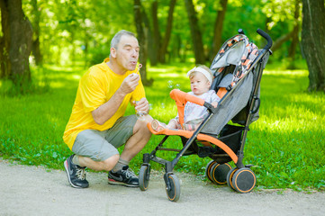 Daddy and daughter blowing a bubbles in the park