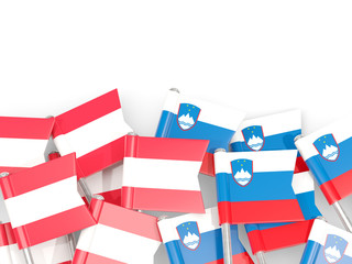 Flag pins of Austria and Slovenia isolated on white