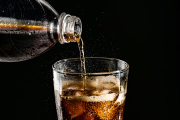 poured beverrage into a glass with ice,Cola drink is fizzy
