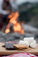 Smores Ingredients at a Beach Bonfire with Chocolate, Marshmellow, and Graham Crackers with Room for Copy