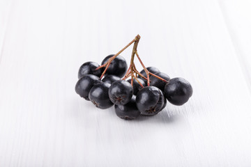Bunch of black chokeberry ( Aronia ) on white background